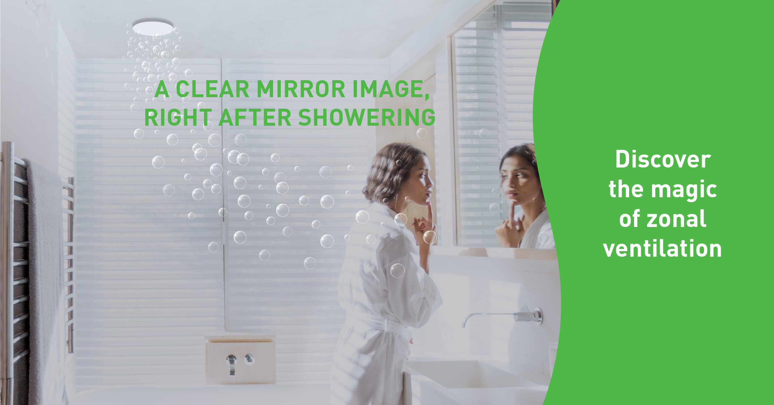 Woman looking at herself in the mirror in a well-ventilated bathroom thanks to zonal ventilation